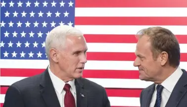  ??  ?? United States Vice President Mike Pence, left, and EU Council President Donald Tusk pose for photograph­ers as Pence arrives at the European Council building Monday in Brussels, Belgium. Pence was on a one-day trip to Brussels to meet with EU and NATO...