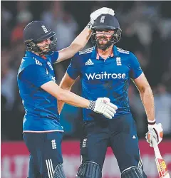  ??  ?? Strike Two! Plunkett celebrates with Chris Woakes after his last-ball six tied an ODI against Sri Lanka last summer