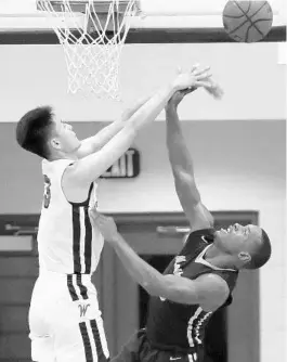  ?? STEPHEN M. DOWELL/ORLANDO SENTINEL ?? Windermere Prep’s Fanbo Zeng rejects a shot attempt by Terrance Gibbs of Master’s Academy on Thursday. Zeng, a 6-foot-9 sophomore, blocked seven shots in the win.