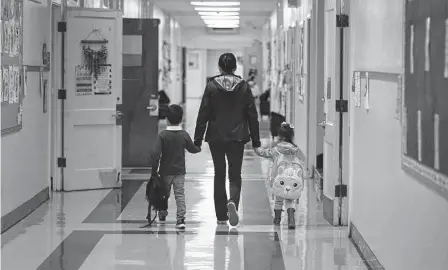  ?? Kin Man Hui/staff photograph­er ?? San Antonio ISD students are escorted to their classrooms at Graebner Elementary on Feb. 8. We should learn our lessons from the mistakes of the U.S. Supreme Court decision 50 years ago in San Antonio ISD v. Rodriguez and give our students a fair chance in education, writes Al Kauffman.