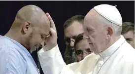  ?? FOCUS FEATURES ?? Pope Francis blesses a man in “Pope Francis: A Man of His Word.”