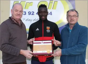  ??  ?? Peter O’Connor receiving his athlete of the month award from Seamus Darcy (Mr Oil) and Paddy Morgan.