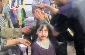  ?? REUTERS ?? A girl looks on following an alleged chemical weapons attack in the rebel held town of Douma, Syria in this still image from video obtained on Sunday.