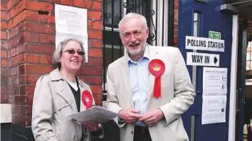  ?? AFP ?? Opposition Labour party leader Jeremy Corbyn (right) speaks to a party activist as he arrives at a polling station to vote in local elections in London yesterday.