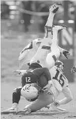  ?? Associated Press ?? Northweste­rn’s Justin Jackson, left, is upended by Iowa’s Joshua Jackson during the second half of an NCAA college football game Oct. 21 in Evanston, Ill. In his first season as a starter, Iowa’s Joshua Jackson leads the nation in passes defended,...