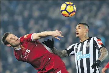  ?? — GETTY IMAGES ?? James Milner, left, vies for the ball with Newcastle United’s Kenedy during their English Premier League match at Anfield in Liverpool on Saturday.