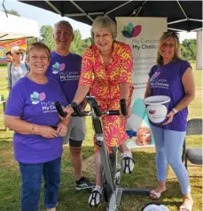  ?? All pictures: Steve Smyth ?? Sally Radford, Mike Ismay and Julia Winmill with Theresa May MP as she takes a cycle challenge on the “My Cancer, My Choices” Stand