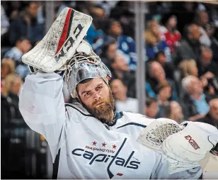  ?? KEVIN SOUSA GETTY IMAGES FILE PHOTO ?? Goaltender Braden Holtby of the Washington Capitals puts on his mask against the Maple Leafs at the Scotiabank Arena in Toronto on Feb. 21, 2019. The Vancouver Canucks signed Holtby to a two-year, $8.6-million (U.S.) contract as part of the leaguewide crease carousel.