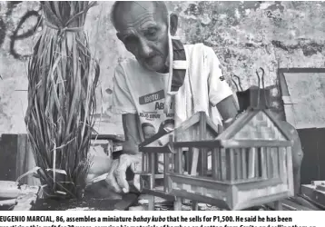  ?? ROY DOMINGO ?? EUGENIO MARCIAL, 86, assembles a miniature bahay kubo that he sells for P1,500. He said he has been practicing this craft for 20 years, sourcing his materials of bamboo and rattan from Cavite and selling them on a vacant lot in Makati City, a trade that has helped to tide him over the pandemic.