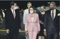  ?? Taiwan Ministry of Foreign Affairs ?? NANCY PELOSI, with Foreign Minister Joseph Wu, left, as she arrives as the highest-ranking elected U.S. official to visit Taiwan since 1997.