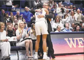  ?? Jessica Hill / Associated Press ?? UConn head coach Geno Auriemma embraces Napheesa Collier after Collier came out of the game against South Carolina on Monday night.