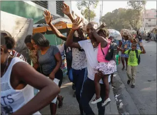  ?? ODELYN JOSEPH/ASSOCIATED PRESS ?? Residents flee their homes during clashes between police and gang members at the Portail neighborho­od in Port-au-Prince, Haiti, on Feb. 29. Many people in the U.S., including lawmakers seem numb to the violence.