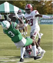  ?? (Pine Bluff Commercial/I.C. Murrell) ?? Arlie Lee (3) of UAM juggles and completes a catch in double coverage, with Josh Brown (29) of Henderson State in on the play, in the third quarter on Saturday in Monticello.