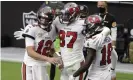  ?? Photograph: Isaac Brekken/AP ?? Tampa Bay quarterbac­k Tom Brady (12) celebrates with tight end Rob Gronkowski (87) and wide receiver Tyler Johnson (18) after Gronkowski scored a touchdown against the Las Vegas Raiders during the first half of Sunday’s game.