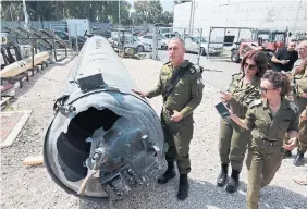  ?? GIL COHEN-MAGEN AFP VIA GETTY IMAGES ?? Members of the Israeli military show an Iranian ballistic missile that fell in Israel on the weekend, during a media tour at the Julis military base near the southern Israeli city of Kiryat Malachi on Tuesday.