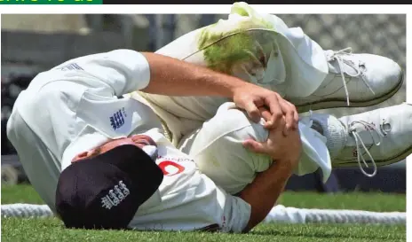  ?? PA AP ?? Horror moment: Simon Jones clutches his knee in agony after wrenching it on the Gabba outfield