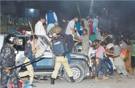  ?? K.M. Chaudary, The Associated Press ?? Police use force to disperse supporters of Nawaz Sharif before his return to Pakistan from London on Friday. Police arrested scores of Pakistan Muslim League party workers.