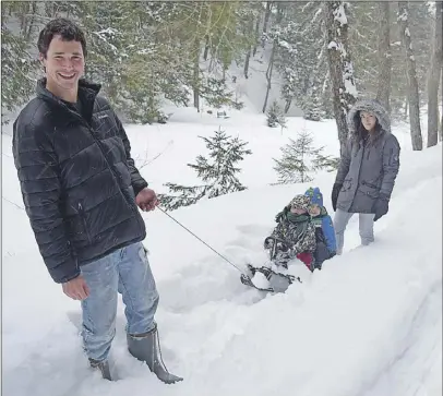  ?? JOnATHAn RILey/TC MedIA ?? Dan MacKinnon and Rachel Brautigam took Hayden Brautigam and James MacKinnon for a sled ride in the fresh, fallen snow of Victoria Park Tuesday.