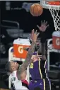  ??  ?? Portland’s Damian Lillard, left, shoots over the Lakers’ Montrezl Harrell Friday. Lillard scored 35 points in a losing effort by the Trail Blazers.