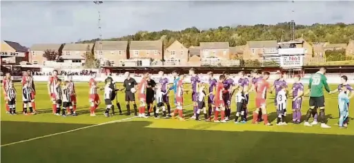  ??  ?? The Huncoat players walking out Accrington Stanley in their match against Cheltenham Town and having a kickabout on the Wham Stadium pitch (below) showing Layne Young, Caleb Bello, Henry Price and goalie Oliver Groves