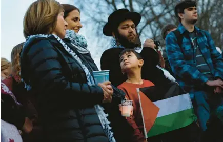  ?? ANNA MONEYMAKER/GETTY ?? People participat­e in a vigil for U.S. Air Force Airman Aaron Bushnell outside the Israeli Embassy on Feb. 26 in Washington. Bushnell died after setting himself on fire in protest of the deaths of Palestinia­ns in Gaza.