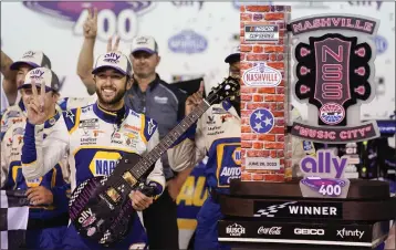  ?? MARK HUMPHREY — THE ASSOCIATED PRESS ?? Chase Elliott poses with his guitar and trophy after winning a NASCAR Cup Series auto race Sunday in Lebanon, Tenn.
