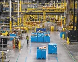  ?? Stephanie Keith Bloomberg ?? ONLINE sales hit a record $9.12 billion on Black Friday, up 2.3% from a year earlier, according to Adobe Analytics. Above, an Amazon warehouse in New Jersey.