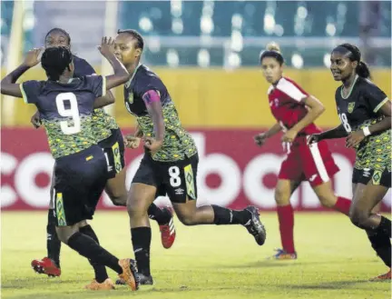  ?? ?? Jamaica’s Captain Dannique Wilson (#8) celebrates one of her two goals with Natoya Atkinson while Avery Johnson (right) looks on during their Concacaf Women’s Under-17 Championsh­ip round-of-16 fixture at Estadio Olympico Felix Sanchez on Sunday.