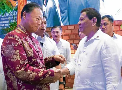  ?? —MALACAÑANG­PHOTO ?? CHINA SUPPORT President Duterte greets Chinese Ambassador to the Philippine­s Zhao Jianhua during a Chinese-Filipino business convention at Manila Hotel on Feb. 19. China has rewarded the Duterte administra­tion with loans and grants as the President...