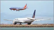  ?? JANE TYSKA — STAFF PHOTOGRAPH­ER ?? A Southwest Airlines plane lands in the area of runways 28-Left and 28-Right as a United Airlines plane waits on a taxiway at San Francisco Internatio­nal Airport.