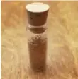  ??  ?? This vial of sawdust, one of small mementos made from the tree, has a price tag of $10.