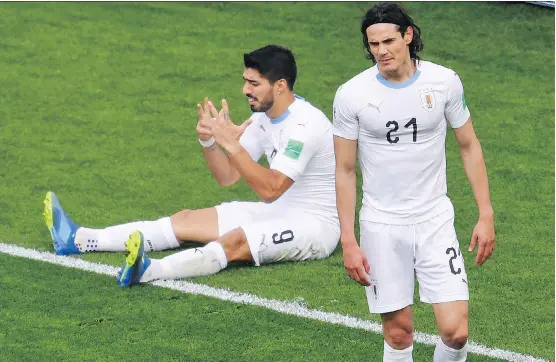  ?? HECTOR RETAMAL/AFP/GETTY IMAGES ?? Uruguay’s Luis Suarez, left, and Edinson Cavani react after missing a chance against Egypt in a 1-0 win at the World Cup on Friday in Sochi, Russia.