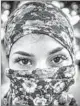  ??  ?? A YOUNG female protester pauses for a portrait amid clashes in Caracas’ east side.