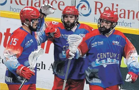  ?? CLIFFORD SKARSTEDT EXAMINER ?? Peterborou­gh Century 21 Lakers’ Corey Small, left, Shawn Evans and Adam Jones celebrate a goal scored on Oakville Rock’s goalie Nick Rose during first period of Game 5 Major Series Lacrosse championsh­ip series at the Memorial Centre on Thursday night. Evans had nine points in a 14-11 win.