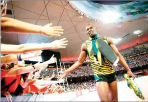  ?? ADRIAN DENNIS/AFP ?? Jamaica’s Usain Bolt celebrates with fans after winning the final of the men’s 200m at the 2015 IAAF World Championsh­ips in Beijing on August 27, 2015.