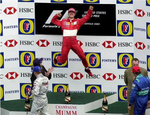  ?? ?? Michael Schumacher wins the 2003 US GP at Indianapol­is CHUCK ROBINSON/AP2003