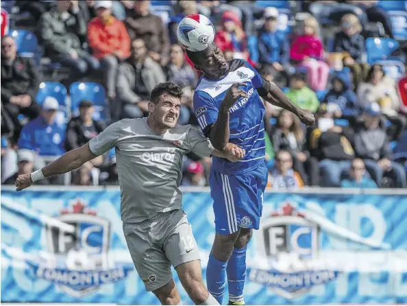  ?? SHAUGHN BUTTS ?? Tomi Ameobi of FC Edmonton gets a touch on the ball before Ramon Martin Del Campo of Puerto Rico FC at Clarke Stadium. The teams played to a 0-0 draw on Sunday, bringing an end to Edmonton’s nine-game home winning streak, one shy of a North American Soccer League record.