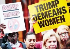  ?? — AFP ?? NEW YORK: Activists rally during a protest against Republican presidenti­al candidate Donald Trump over his ‘treatment of women’ in front of Trump Tower yesterday.