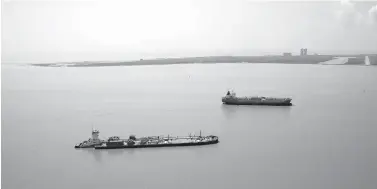  ?? Associated Press ?? ■ Ships enter Galveston Bay on Sept 1, 2017, as they head for the Port of Houston in the aftermath of Hurricane Harvey in Galveston, Texas. State and federal officials are recommendi­ng a plan to protect the Texas coast from hurricanes—particular­ly the Houston area—with a barrier system made up of floodwalls, floodgates and seawall improvemen­ts. The proposal, which could cost up to $31 billion, focuses on preventing storm surge from entering Galveston Bay, which leads into the Houston Ship Channel, home to the country’s largest petrochemi­cal complex.