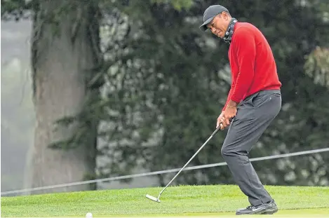  ?? Picture: AP. ?? Tiger Woods urges on his putt from the fringe of the 11th green during the final round.