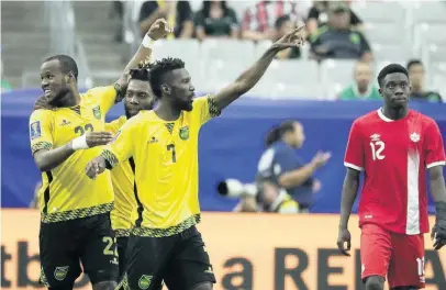  ?? AP ?? Jamaica’s Romario Williams (left) is congratula­ted by his team-mates after he scored his team’s second goal against Canada during a CONCACAF Gold Cup quarter-final match on July 20, 2017, in Glendale, Arizona.