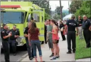  ??  ?? People stand alongside firetrucks for National Night Out in Royersford on Washington Street Tuesday evening.