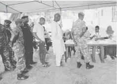  ??  ?? Police and military personnel queue to vote during the presidenti­al election in Banjul, Gambia. — Reuters photo