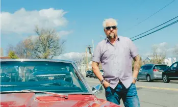  ?? TIMOTHY O’CONNELL/THE NEW YORK TIMES ?? Guy Fieri stands April 1 next to his red Camaro while filming in New Jersey.