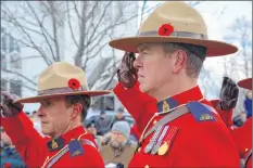  ??  ?? Members of the RCMP salute during the Remembranc­e Day ceremony.