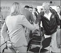  ?? AP/EVAN VUCCI ?? Carmen Yulin Cruz, mayor of San Juan, Puerto Rico, greets President Donald Trump at a briefing for the president at Luis Muniz Air National Guard Base in San Juan. “I saw a real connection between the reality and the White House staff,” Cruz, who had...