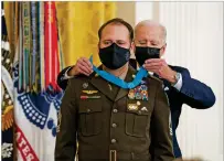  ?? DOUG MILLS/NEW YORK TIMES ?? President Joe Biden presents the Medal of Honor to Master Sgt. Earl D. Plumlee for his acts of gallantry above and beyond the call of duty while serving with the Army in Afghanista­n in 2013.
