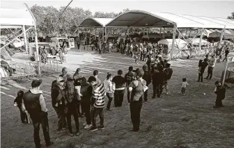  ?? Jerry Lara / Staff file photo ?? A line forms for food at the migrants camp in Matamoros, Mexico, in February. As recently as June, the camp was home to 2,500 asylum-seekers. But only about 1,000 migrants are there now.