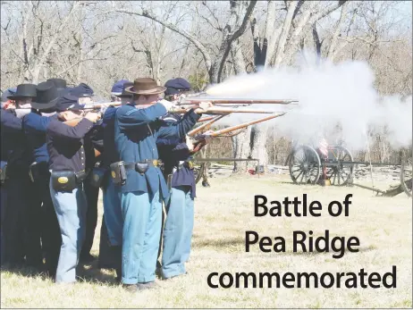  ?? TIMES photograph by Annette Beard ?? Fire glowed from a replica rifle as Union soldiers re-enactors of Company B, 24th Missouri, fired a volley while demonstrat­ing infantry maneuvers during the 154th anniversar­y of the Battle of Pea Ridge Saturday. Reenactors set up camps and demonstrat­ed...