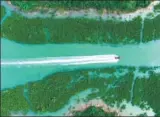  ?? HUANG XIAOBANG / XINHUA ?? A yacht sails through mangrove swamps in a natural reserve area in Qinzhou, the Guangxi Zhuang autonomous region, in May.